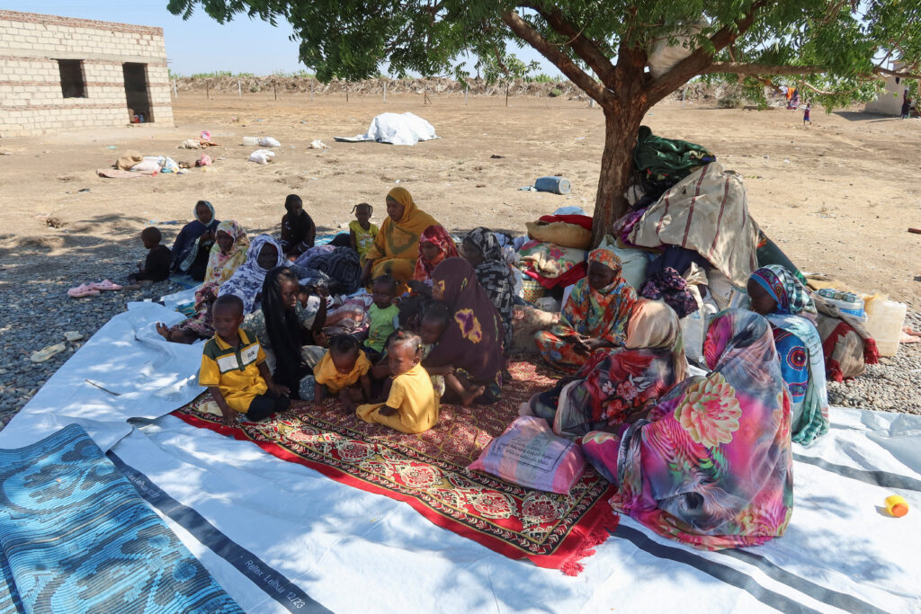 Sudanese people, displaced from Gezira state due to Hemedti RSF violence, sit under a tree in New Halfa, Kassala state, Sudan,