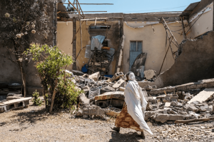 A Tigrayan woman navigates streets lined with destroyed buildings in Tigray, reflecting the human impact of the $10.86 billion damage caused by Ethiopia's Tigray War